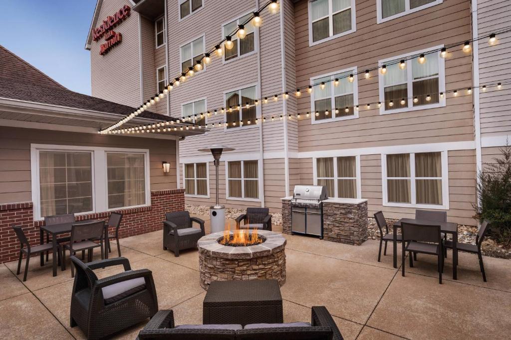a patio with chairs and a fire pit in front of a building at Residence Inn by Marriott Philadelphia West Chester/Exton in Exton
