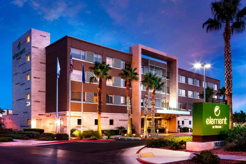 a hotel with palm trees in front of a building at Element Las Vegas Summerlin in Las Vegas
