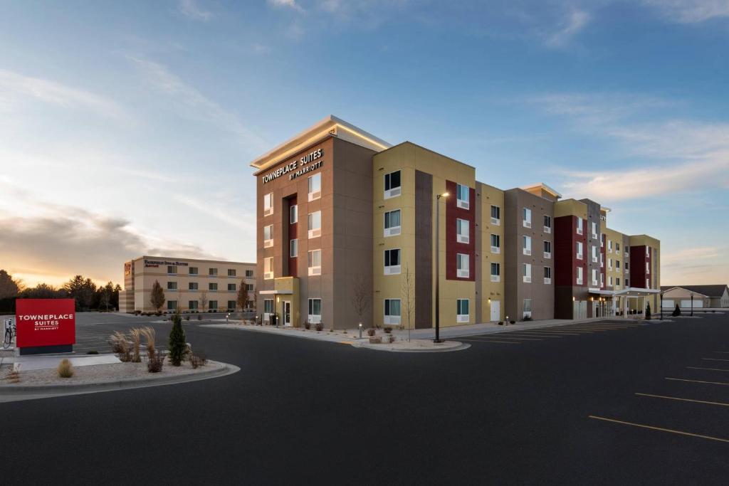 a rendering of an apartment building with a parking lot at TownePlace Suites by Marriott Twin Falls in Twin Falls