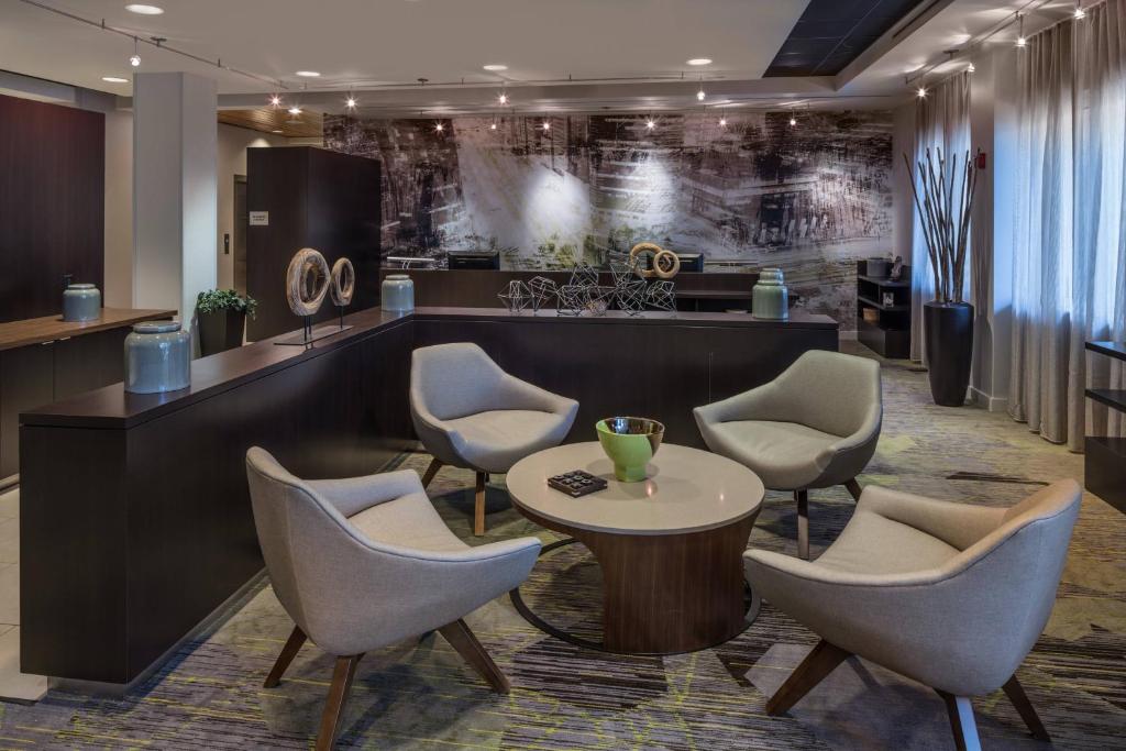 a lobby with chairs and a table and a counter at Courtyard by Marriott Miami West/FL Turnpike in Miami