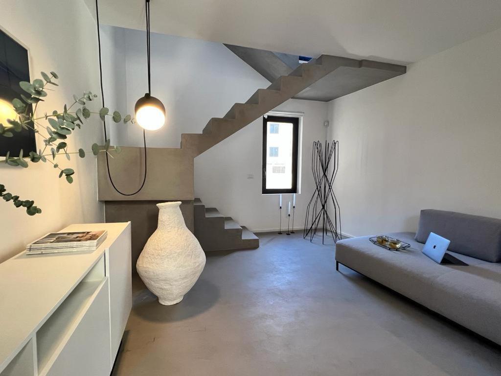 a living room with a couch and a vase at Terme Luxury Suite in Taormina
