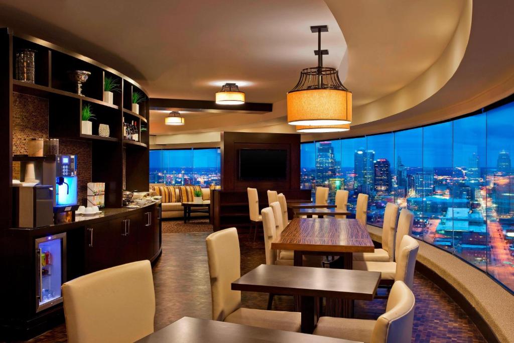 a restaurant with tables and chairs and a view of the city at Sheraton Kansas City Hotel at Crown Center in Kansas City