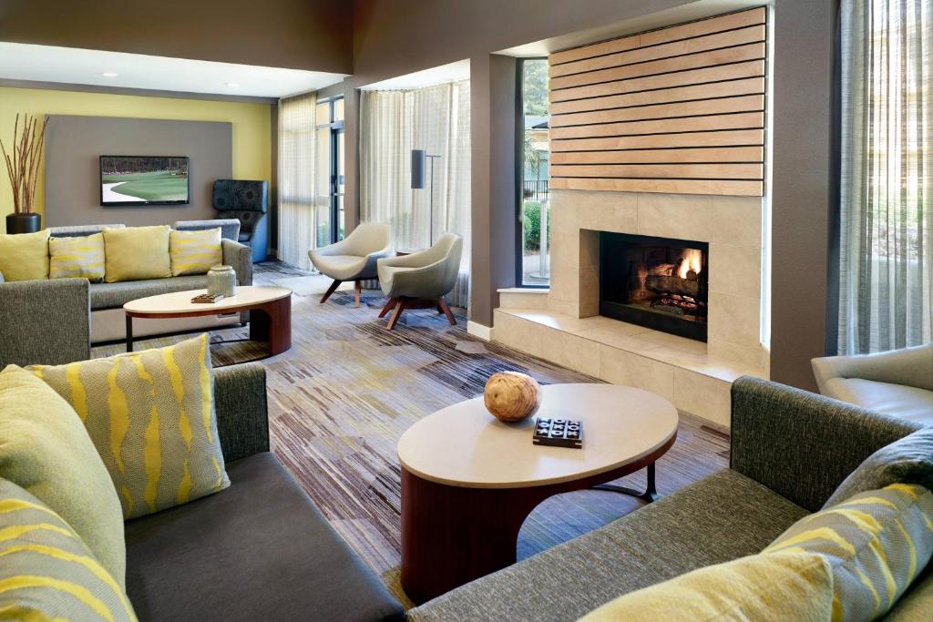 a living room with couches and a fireplace at Courtyard by Marriott Macon in Macon