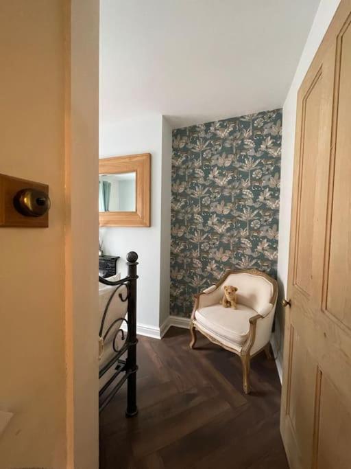 a dog sitting in a chair in a room at The Railway Cottage Bridgnorth in Bridgnorth