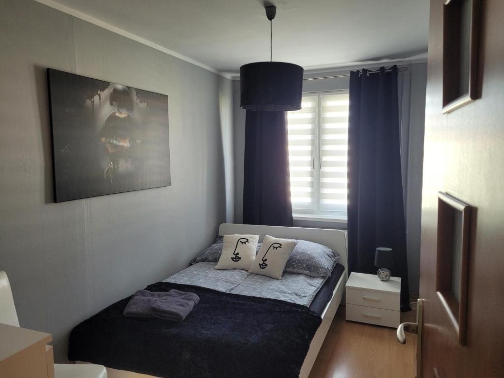Posteľ alebo postele v izbe v ubytovaní Apartament Palisadowa