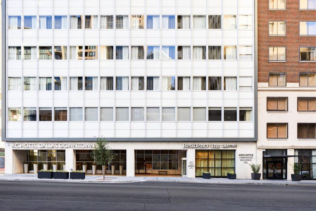 a large white building with a street in front of it at AC Hotel by Marriott Dallas Downtown in Dallas