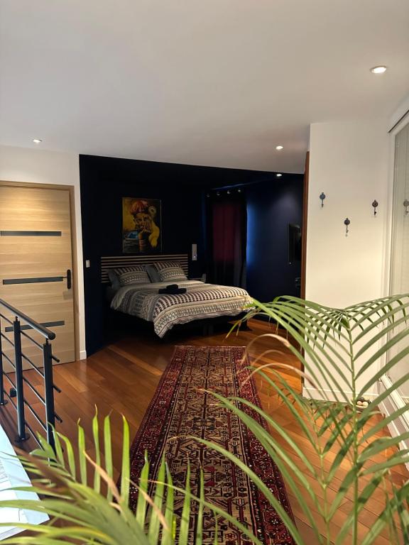 a bedroom with two beds and a large rug at Pink Tropical Champagne in Reims