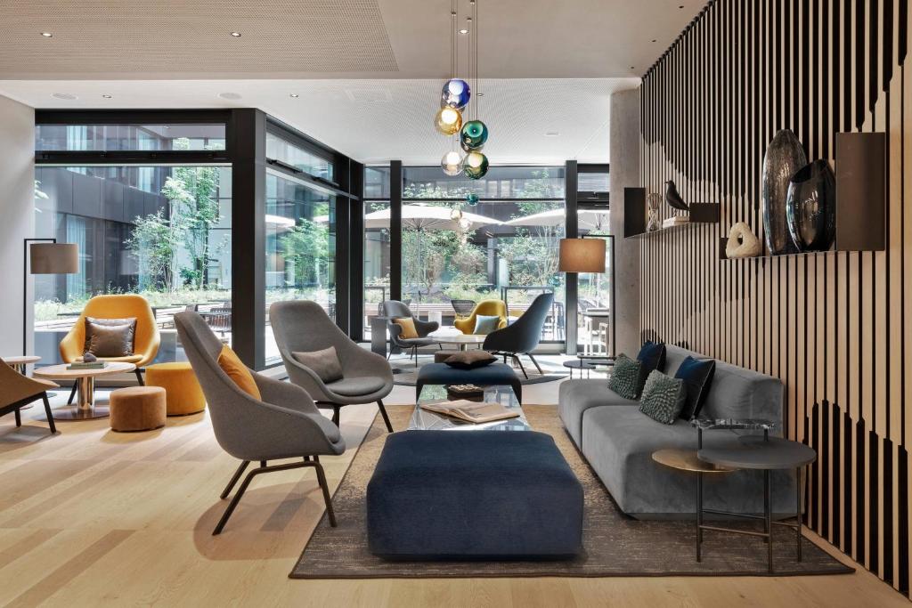 a living room with a couch and chairs at Courtyard by Marriott Freiburg in Freiburg im Breisgau