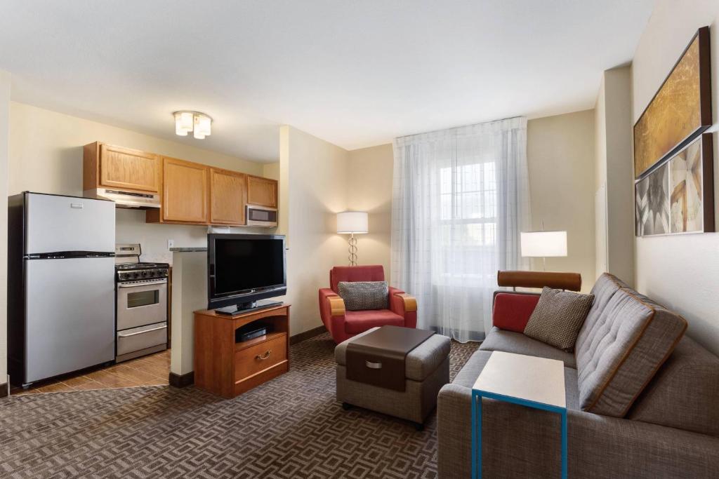 a living room with a couch and a kitchen at TownePlace Suites Salt Lake City Layton in Layton