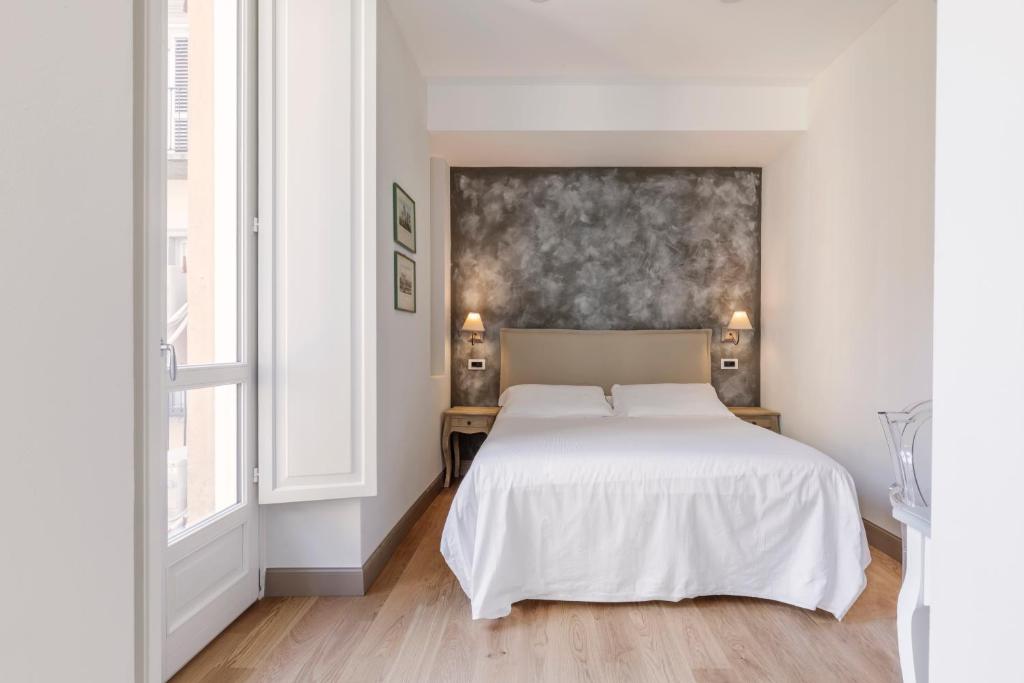 Postel nebo postele na pokoji v ubytování XX SETTEMBRE Urban Relais