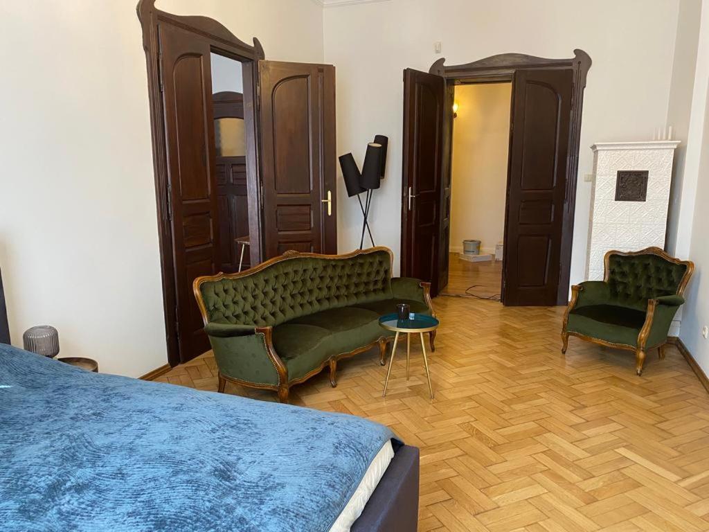 a bedroom with a bed and two chairs and a table at Apt * Stella in Wrocław