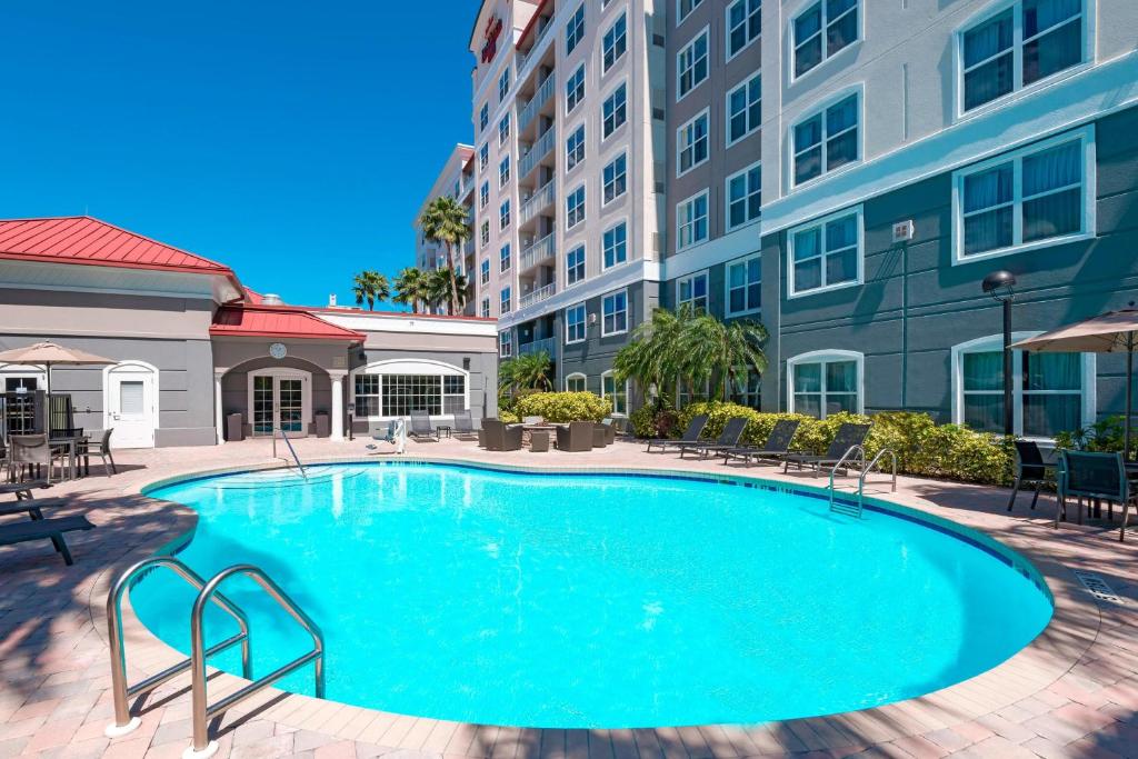 a large swimming pool with chairs and buildings at Residence Inn Tampa Westshore Airport in Tampa