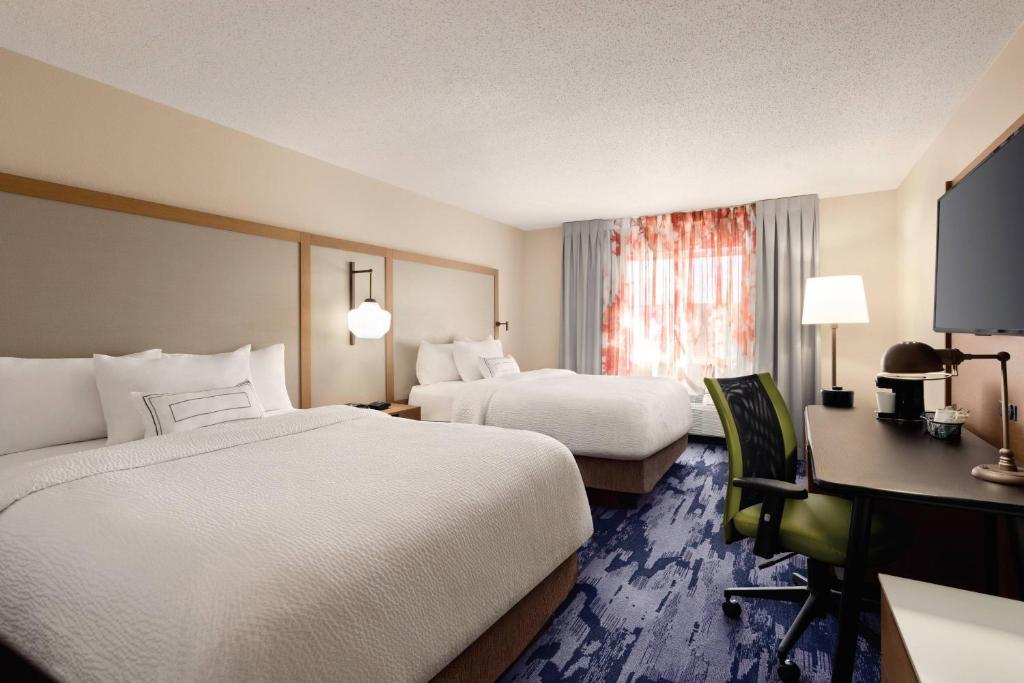 a hotel room with two beds and a desk at Fairfield Inn Scranton in Scranton