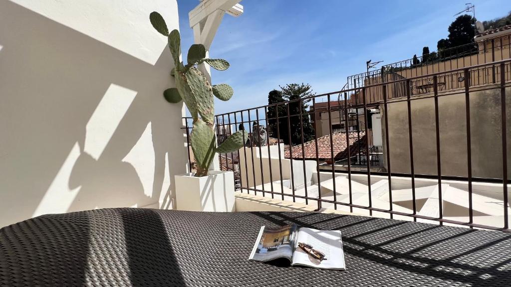 a remote control sitting on a bed next to a fence at Terme Luxury Suite in Taormina