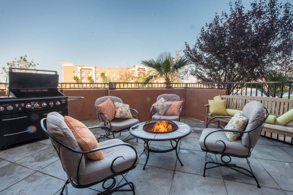 a patio with chairs and a table and a fire pit at SpringHill Suites Ridgecrest in Ridgecrest