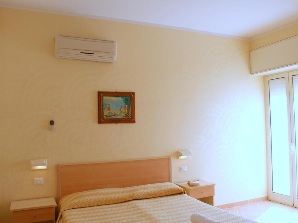 Postel nebo postele na pokoji v ubytování Residence Fontana Vecchia