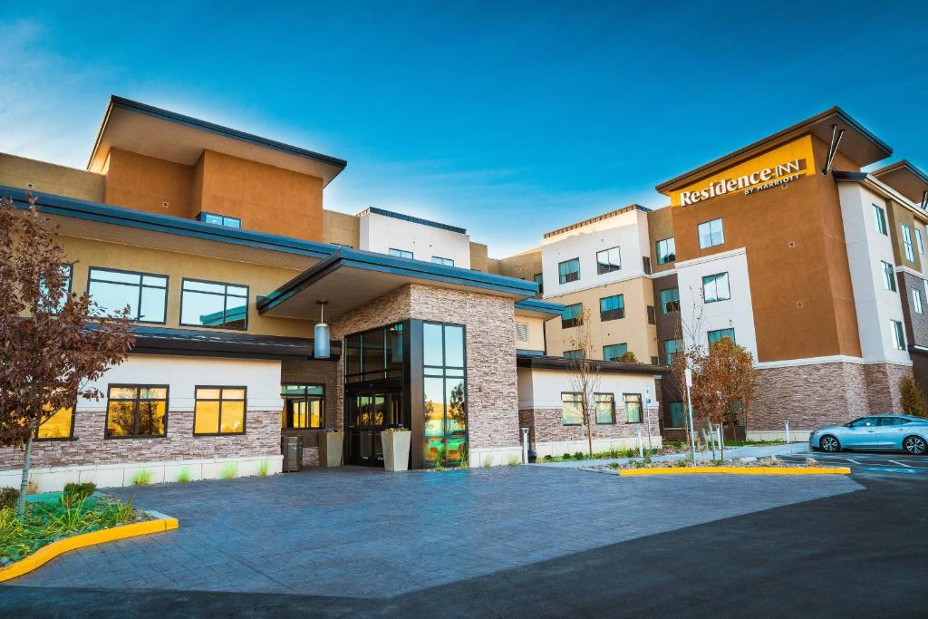 a building with a car parked in a parking lot at Residence Inn by Marriott Reno Sparks in Sparks