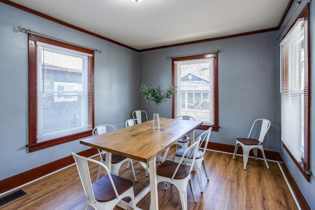 a dining room with a wooden table and chairs at Spacious Home with In-Unit Laundry, Parking, 1GB WiFi, & Patio Deck in Rochester