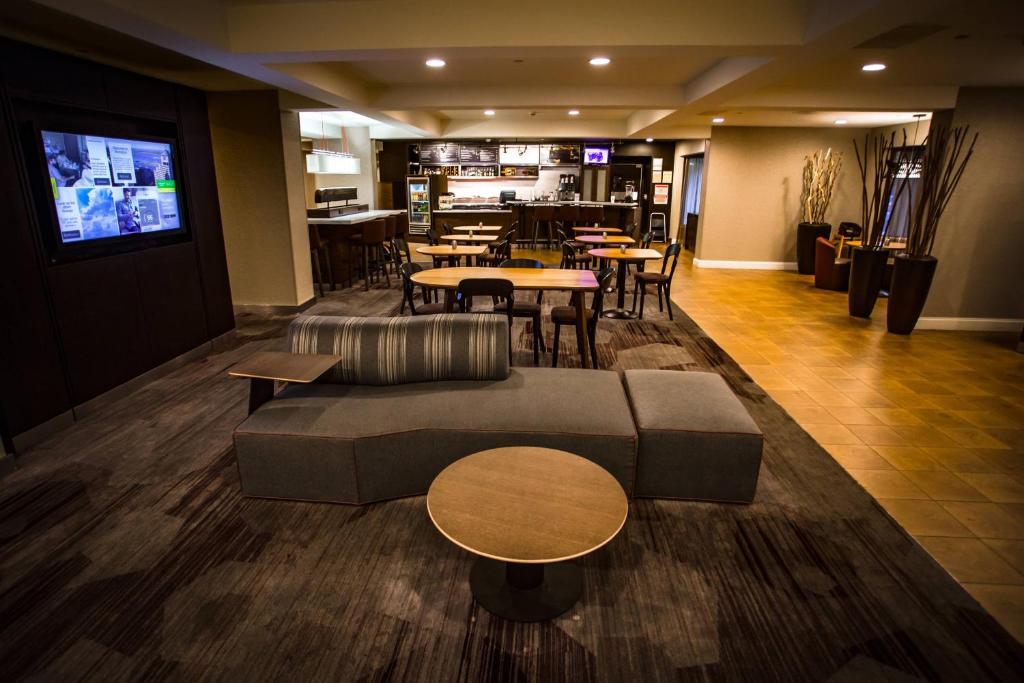 a lobby of a hotel with a couch and tables at Courtyard Memphis East/Bill Morris Parkway in Memphis