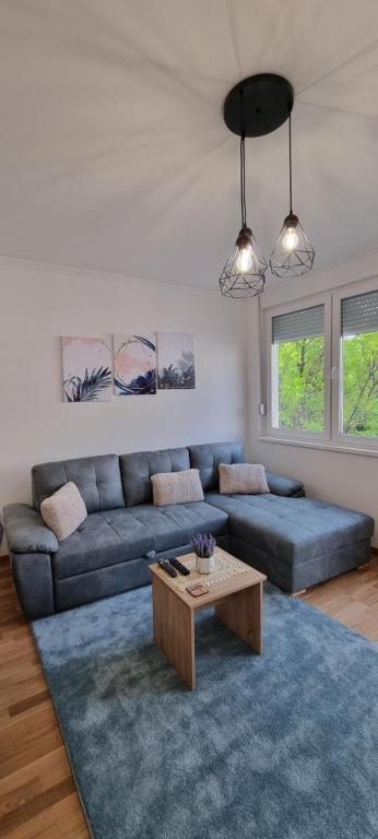 a living room with a couch and a coffee table at Apartman Visnja in Subotica
