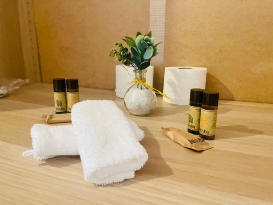 a pile of towels and cosmetics on a table at Le floquet in Vitry-sur-Seine