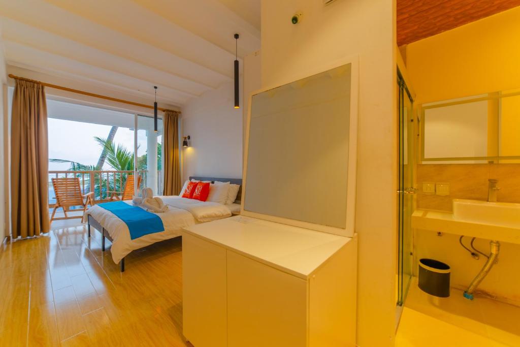 Postel nebo postele na pokoji v ubytování Si! Coral Inn