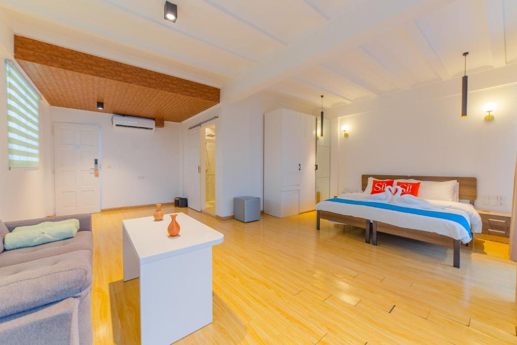 Postel nebo postele na pokoji v ubytování Si! Coral Inn