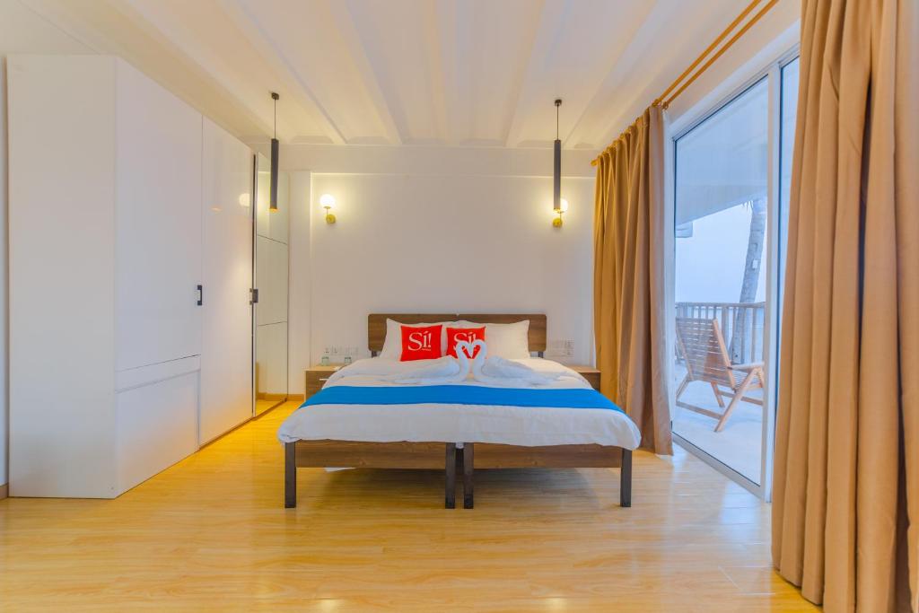 Postel nebo postele na pokoji v ubytování Si! Coral Inn