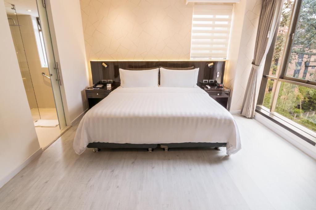 Postel nebo postele na pokoji v ubytování GHL Hotel Portón Medellín
