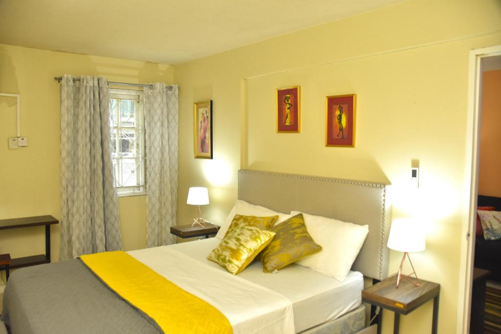 una camera da letto con un letto con cuscini dorati di The flat@Waterloo a Kingston