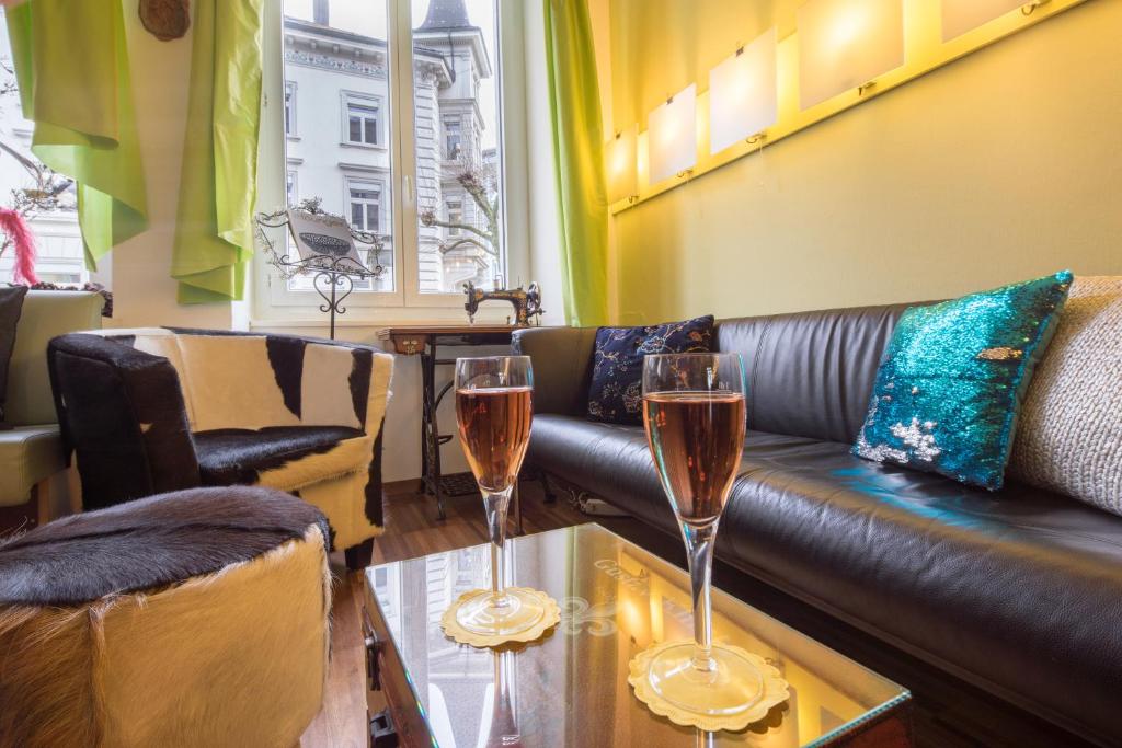 two glasses of champagne on a table in a living room at Hotel Ambassador in Solothurn