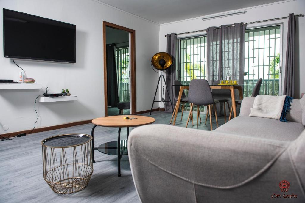 a living room with a couch and a table at Appartement moderne à la Marina du Gosier in Le Gosier