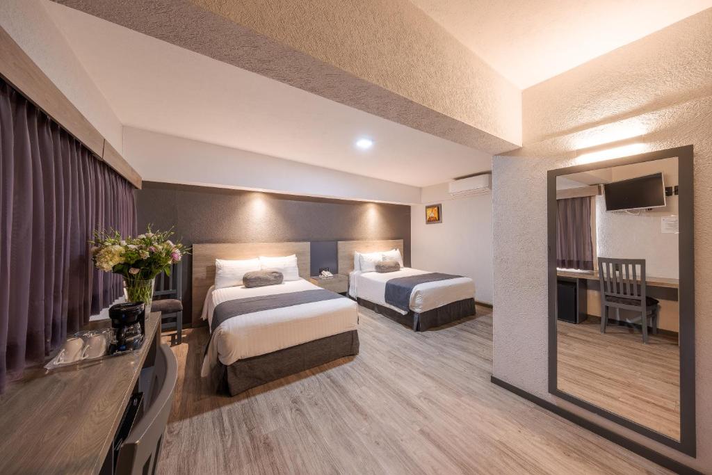 Postel nebo postele na pokoji v ubytování Hotel Malibu