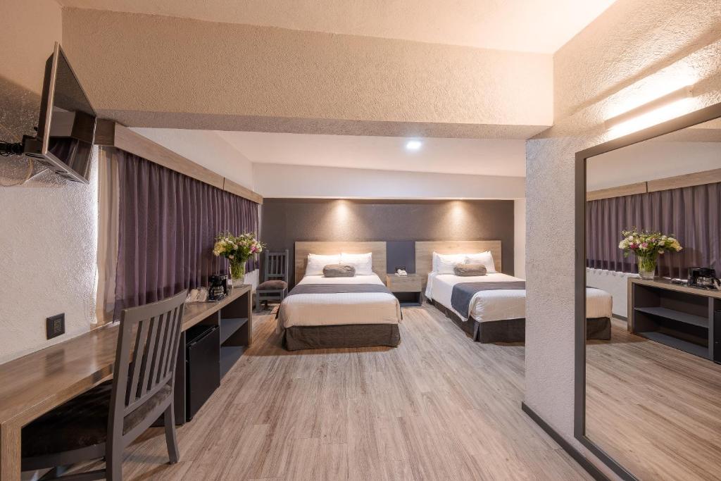 Postel nebo postele na pokoji v ubytování Hotel Malibu