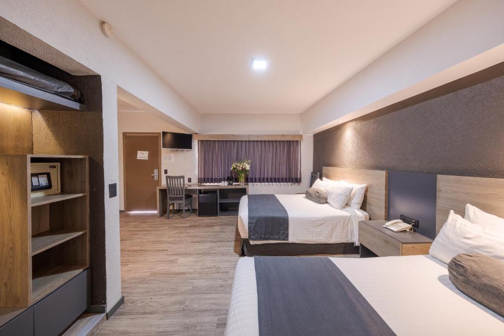 Postel nebo postele na pokoji v ubytování Hotel Malibu