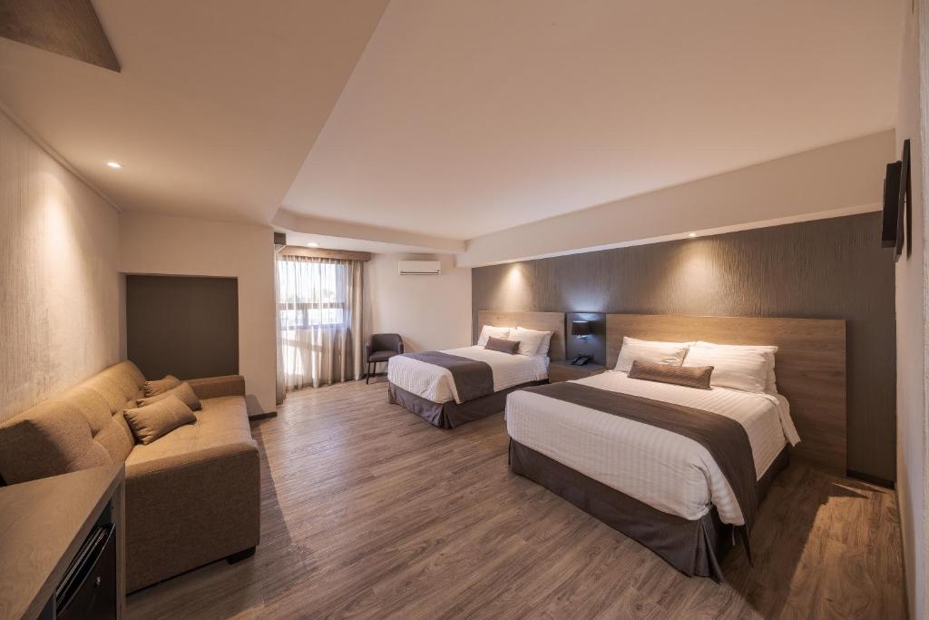 Postel nebo postele na pokoji v ubytování Hotel Malibu