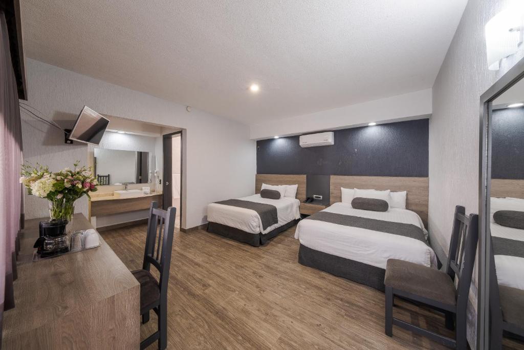 Postel nebo postele na pokoji v ubytování Hotel Malibu