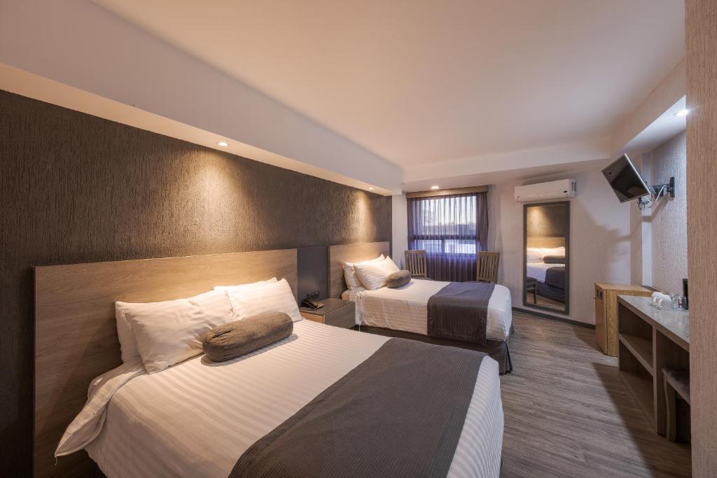 Postel nebo postele na pokoji v ubytování Hotel Malibu