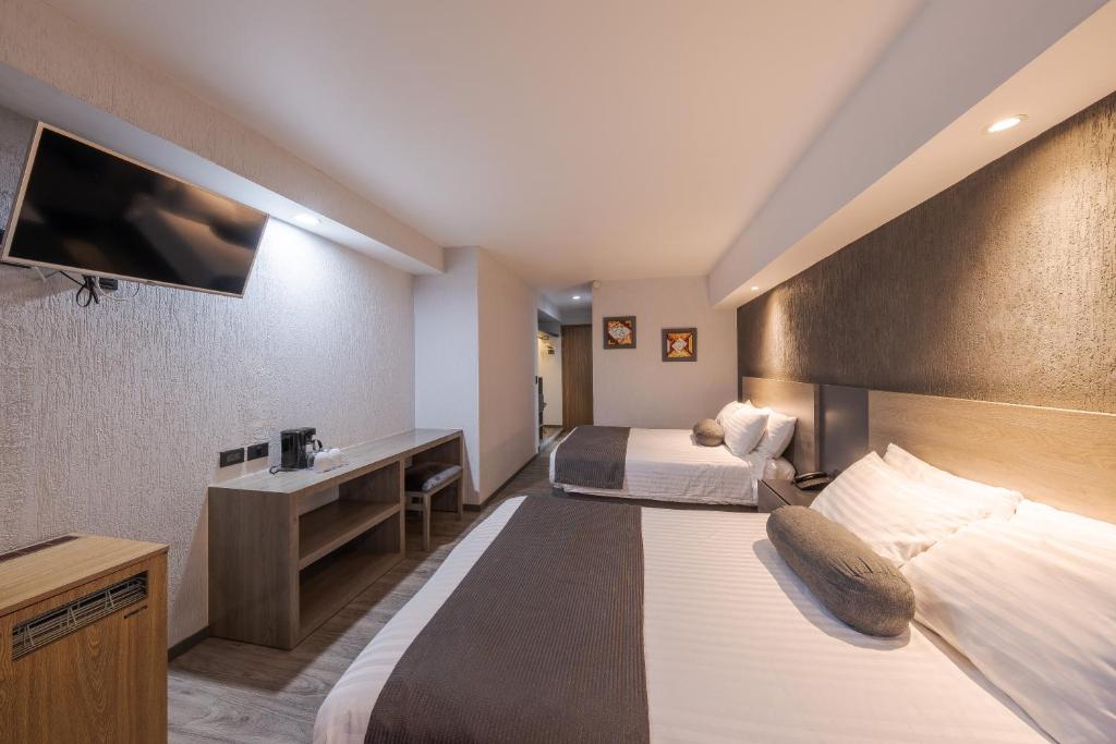 Postel nebo postele na pokoji v ubytování Hotel Malibu