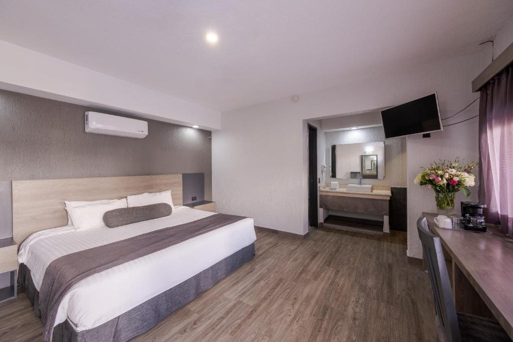 Postel nebo postele na pokoji v ubytování Hotel Malibu