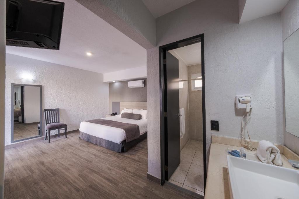 Postel nebo postele na pokoji v ubytování Hotel Malibu