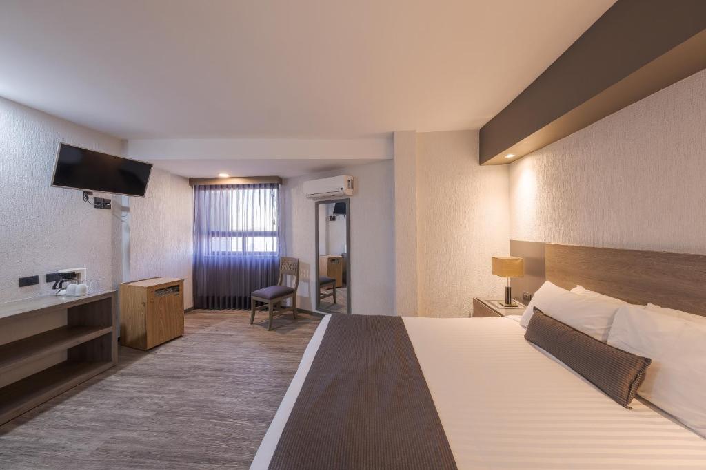 Postel nebo postele na pokoji v ubytování Hotel Malibu