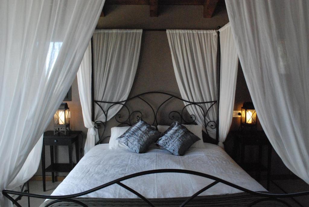 a bedroom with a bed with two pillows at Torre Viladot in Solsona