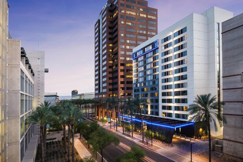 a rendering of a building in a city with palm trees at AC Hotel by Marriott Phoenix Downtown in Phoenix