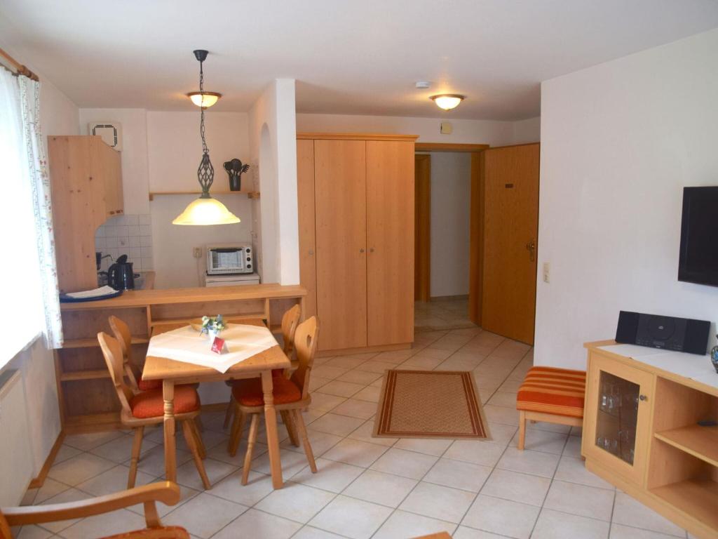 a kitchen and living room with a table and chairs at Lovely Apartment in Bayrischzell with 2 Sauna, Garden and Terrace in Bayrischzell