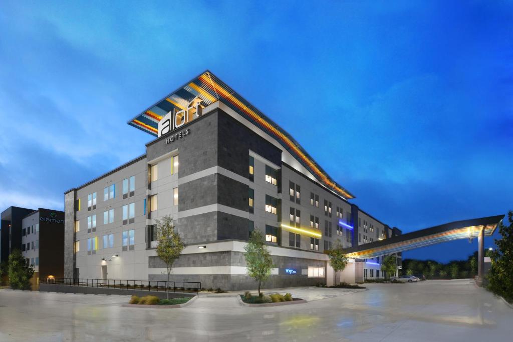 a hotel building with a sign on top of it at Aloft Austin Round Rock in Round Rock