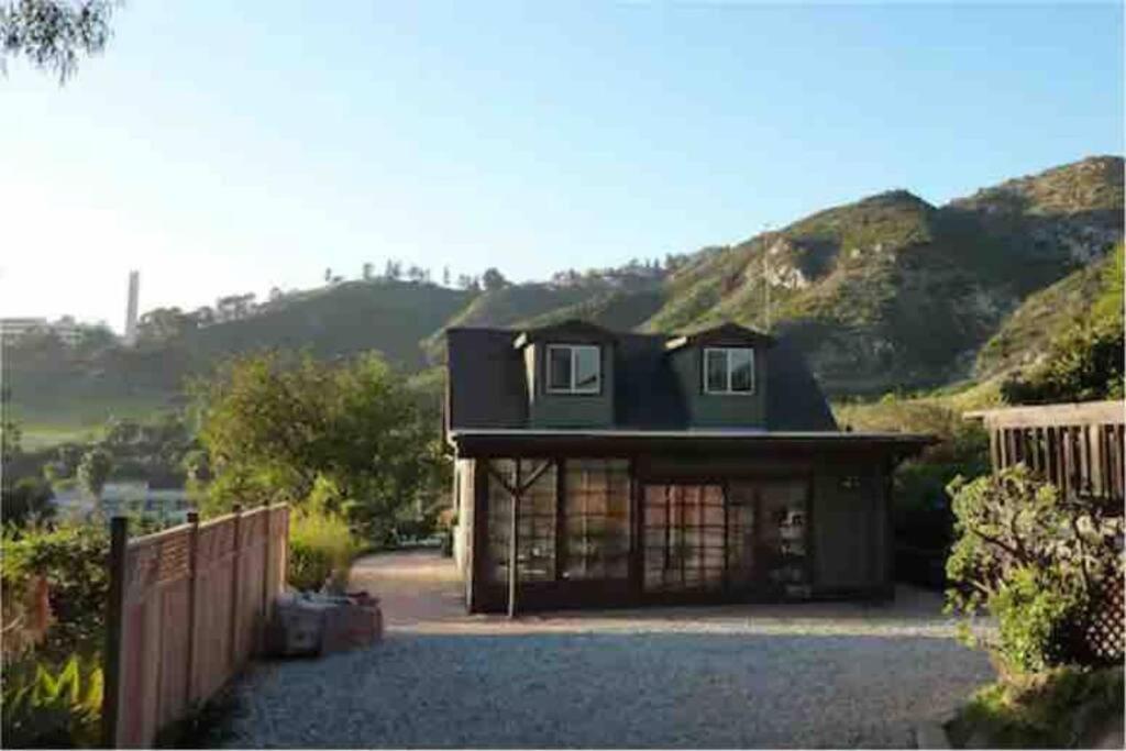 a house with a mountain in the background at Malibu Peaceful Cottage, Near Beach & Hiking Trails in Malibu