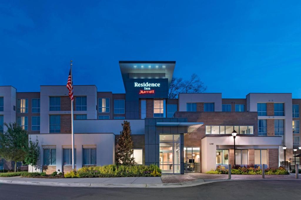 a building with an american flag in front of it at Residence Inn by Marriott Jackson The District at Eastover in Jackson