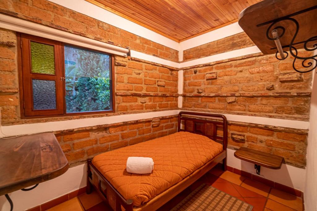Postel nebo postele na pokoji v ubytování Hotel Casa Elemento Villa de Leyva