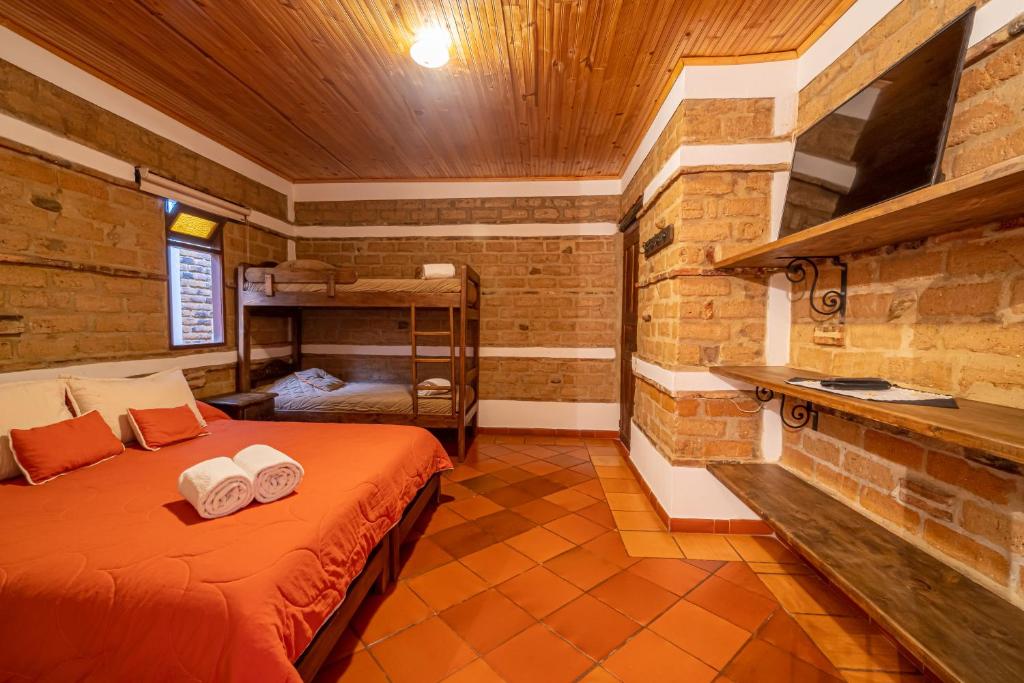 Postel nebo postele na pokoji v ubytování Hotel Casa Elemento Villa de Leyva